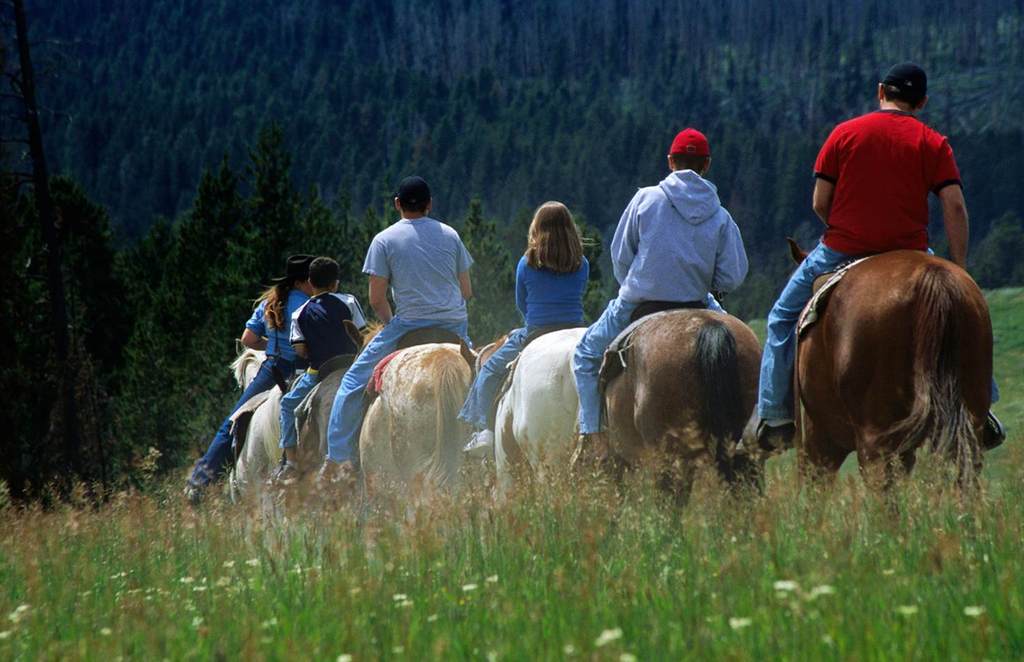 Horseback riding is an adventurous way to hit the trails in Yellowstone National Park © Carol Polich / Getty Images.