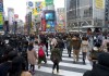 Urban bustle, people crossing a busy cross walk in Shibuya, Tokyo, Japan
