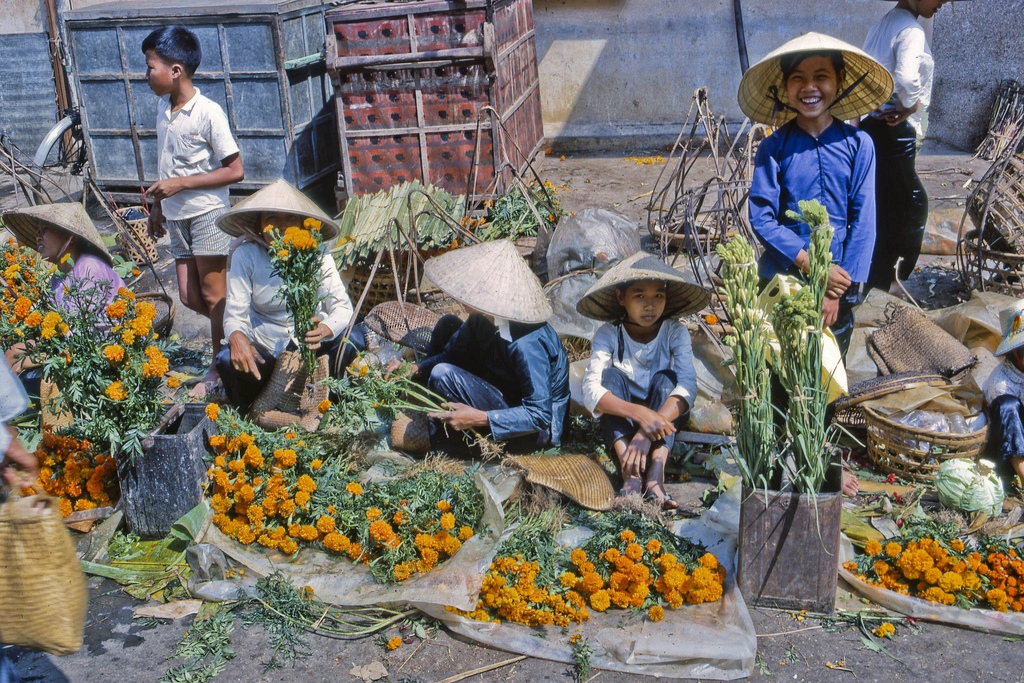 Marigolds for TET in 1969 Flower vendors selling for TET New Year celebration at the My Tho market in Dinh Tuong Province, Vietnam, in the year 1969.