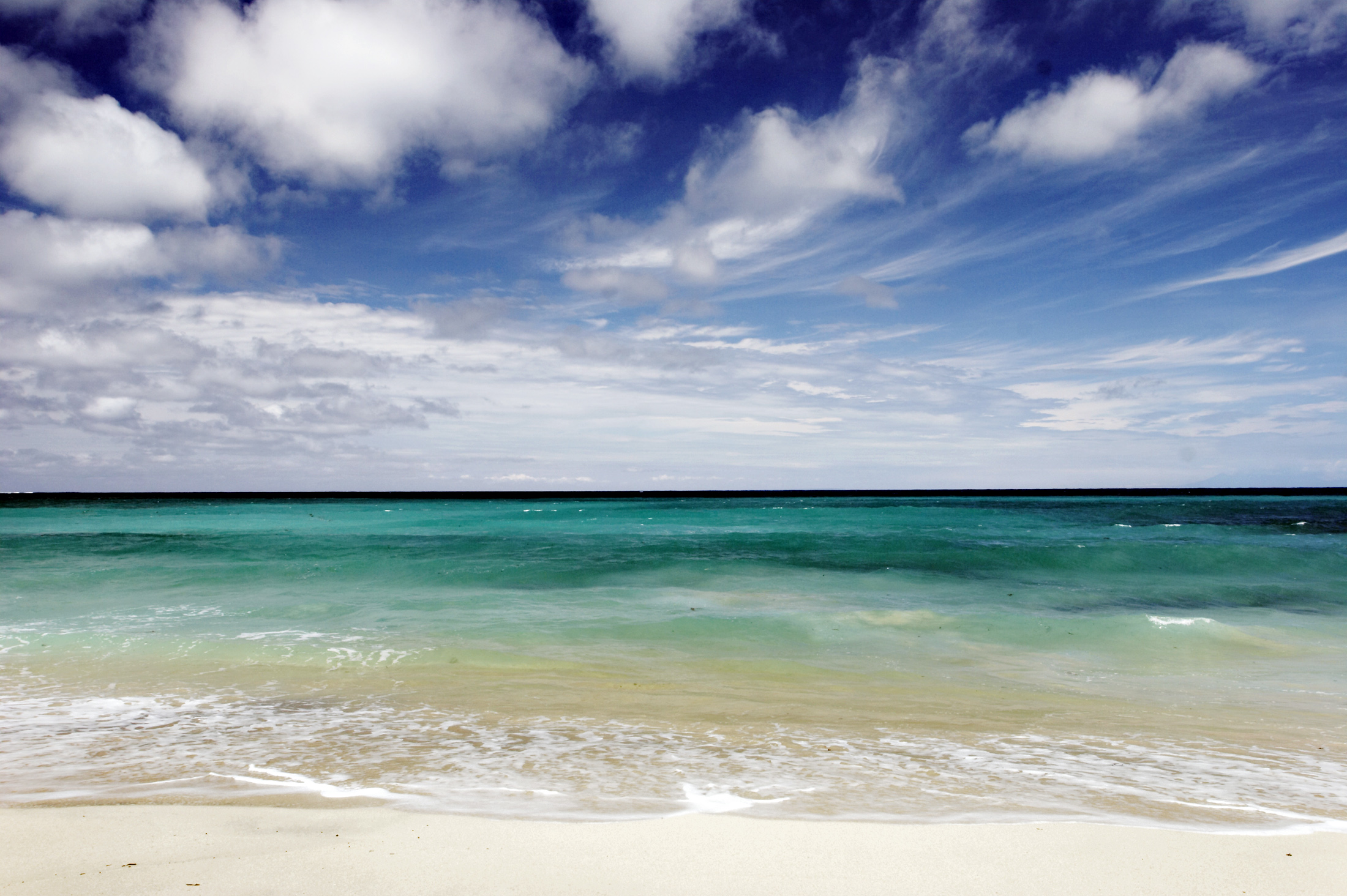 Try your hand at surfing at the beautiful Dreamland Beach in Bali