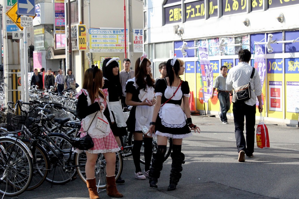 A group of girls on maid costumes on the street in the area of Den Den Town Photo: staticflickr 