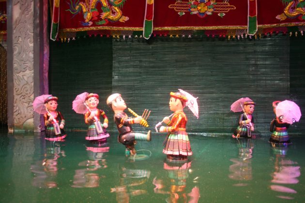 watching water puppet show vietnam travel