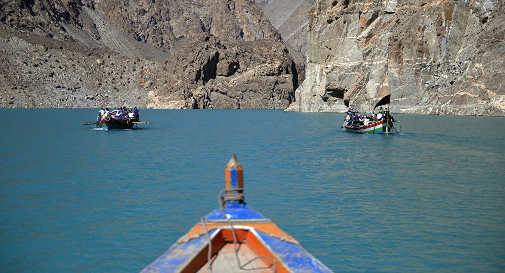 Tourists and locals travel by boat across the Attabad lake in the northern Hunza valley. Image of Pakistan travel blog