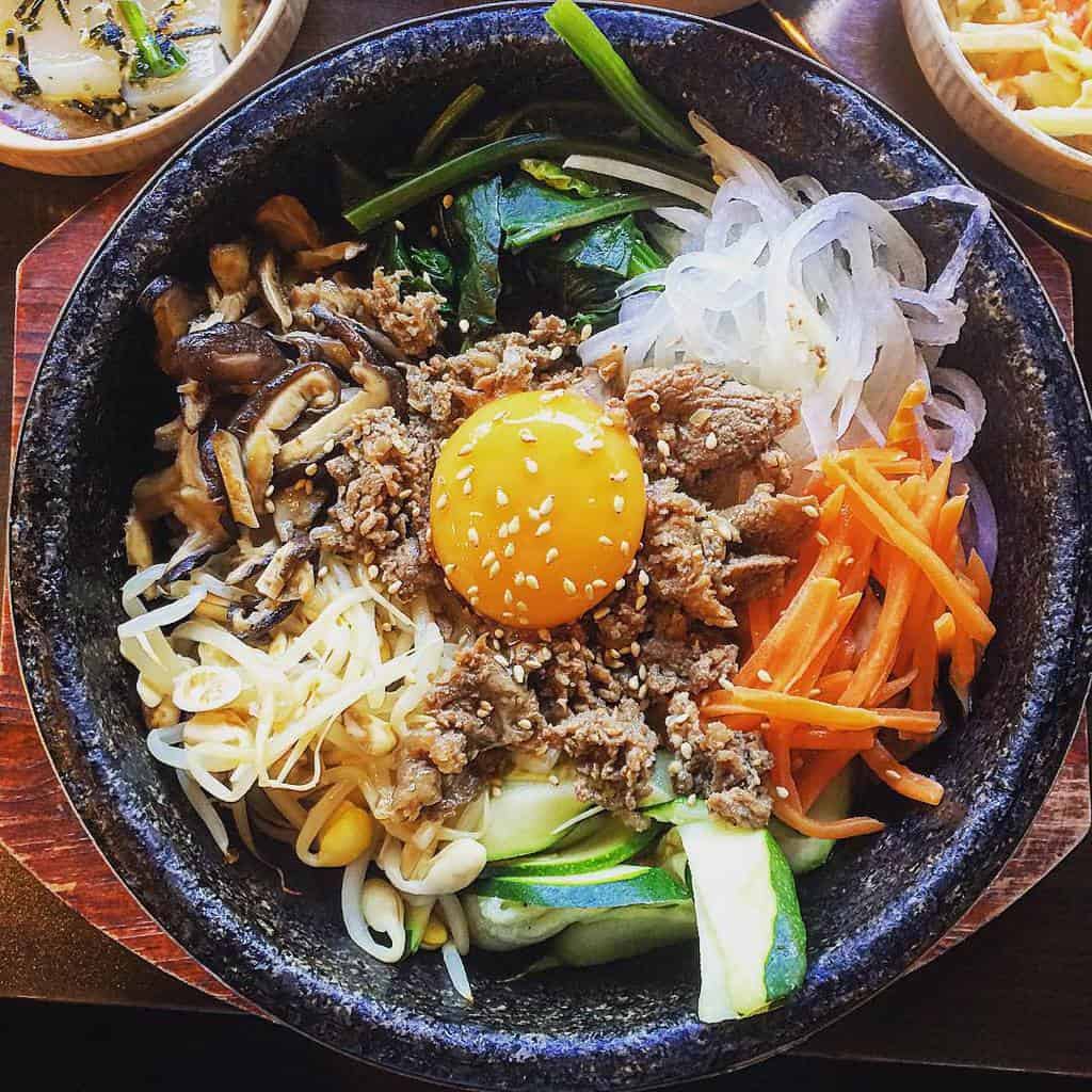 https://livingnomads.com/wp-content/uploads/2019/03/01/bibimbap-korean-must-try-food-must-eat-in-korea-must-eat-korean-food-must-try-food-in-korea-1.jpg