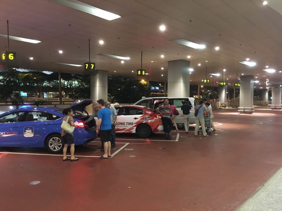 Taxis line up at the taxi bay of Changi International Airport, ready to pick up