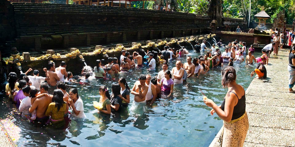 Indonesia, Hindu people in Holy Spring Water Pool at Pura Tirta Empul Temple by documentary travel photographer Matthew Williams-Ellis